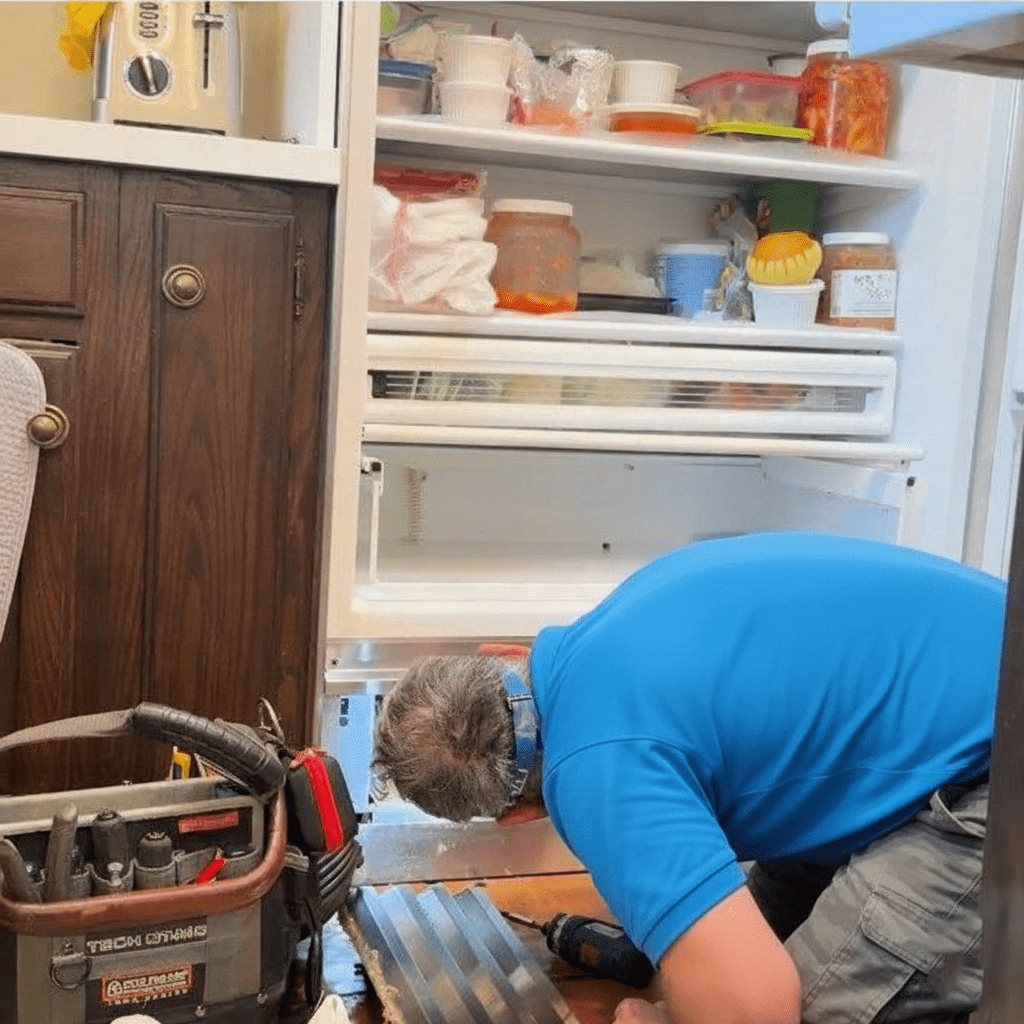 Technician repairing washing machine door